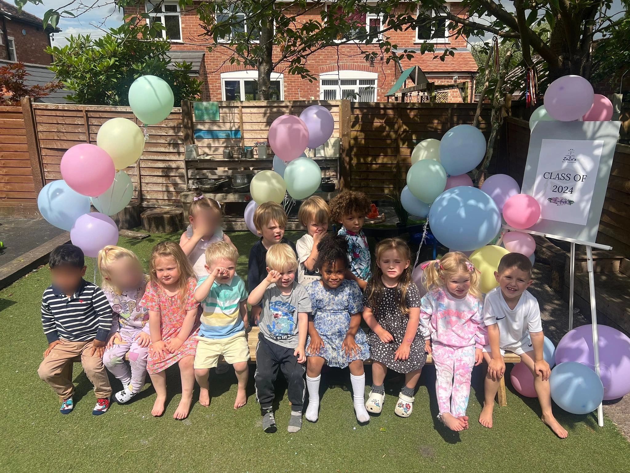 Children gathered in the outdoor garden at ZoZo's